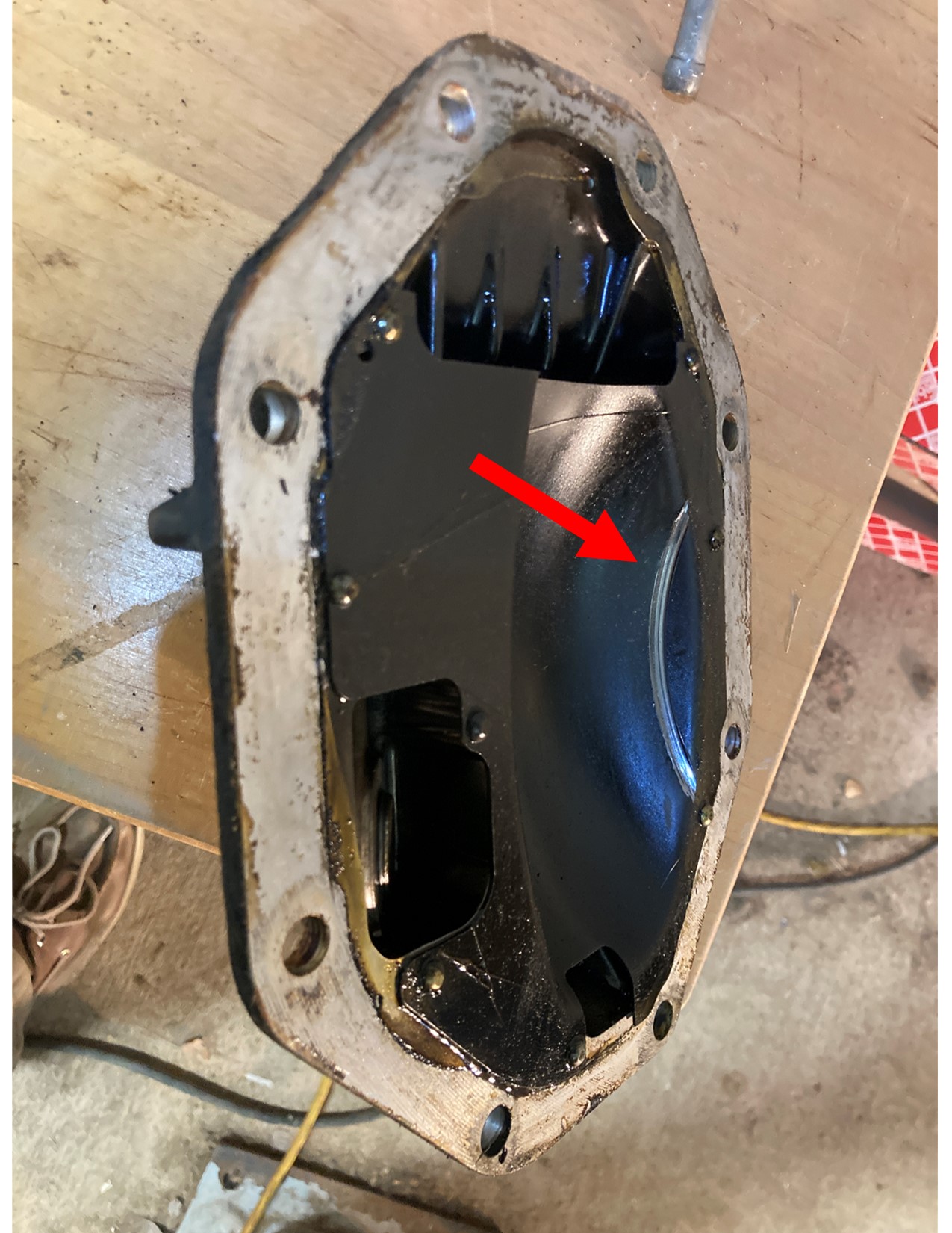 arrow points to mark made by bolt heads on differential rear cover